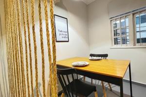a dining room with a wooden table and chairs at APTO charmoso com Suíte, Cozinha completa, Wifi, Smart TV, Ar condicionado in Macaé +3 photos