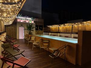 a restaurant with a bar with chairs and a pool at BELLADORA Hotel Boutique in Lloret de Mar