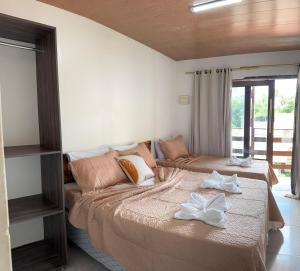 a bedroom with two beds and a couch at Pousada Solare in Maragogi +23 photos