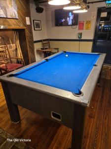 a pool table sitting on the floor in a room at The Old Victoria in Penrith