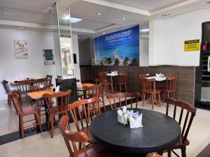 a dining room with a table and chairs in a restaurant at Pousada Solare in Maragogi