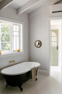 a bath tub in a bathroom with a window at Maleny Lodge in Maleny