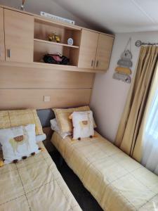 a bedroom with two beds in a trailer at Lisa caravan hire 