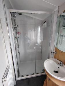 a bathroom with a shower and a sink at Lisa caravan hire  +15 photos