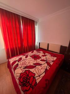 a bedroom with a bed with red curtains at Villa summer house for daily rent in a quiet location in Esenyurt