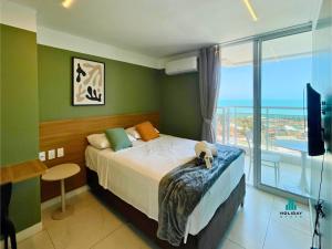 a bedroom with a bed with a view of the ocean at Aquarius Style by Holiday Stays in Fortaleza