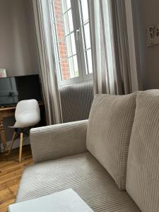 a living room with a couch and a chair at Ferme De Bonavis in Banteux