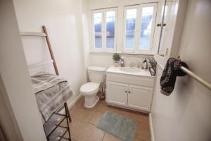 a bathroom with a toilet and a sink and a window at Cozy room in East Holywood, 7 min from holllywood, 15 from downtown, 20 to hollywood sing in Los Angeles