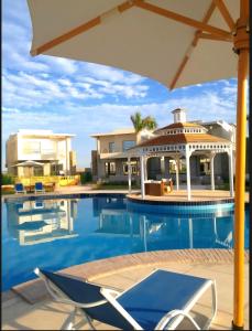 a villa with a swimming pool and a house at Hurghada Sky Villa in Hurghada
