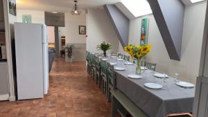 a long dining room with a long table and chairs at La Grange Blanche in Saint-Germain