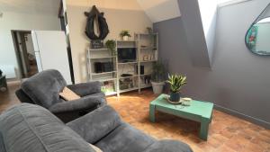 a living room with a couch and a table at La Grange Blanche in Saint-Germain