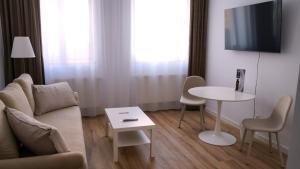 a living room with a couch and a table and a tv at Cristian BV Booking in Cristian +6 photos