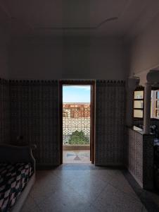a room with a window with a view of a building at Appartement City Center in Ouarzazate