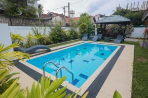 a swimming pool in the backyard of a house at Ayana Beach Garden in Negombo
