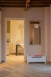 a room with a table and a mirror on the wall at I Gelsi di San Bernardino Apartment in Fiorenzuola dʼArda