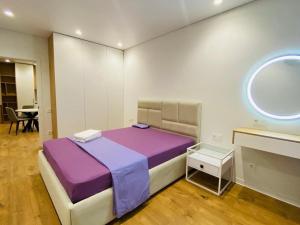 a bedroom with a purple bed and a window at Chișinău Arena in Chişinău