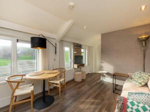 a living room with a table and a couch at Coastal Comfort in Zoutelande in Zoutelande