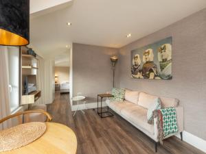 a living room with a couch and a table at Coastal Comfort in Zoutelande in Zoutelande