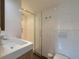 a bathroom with a sink and a toilet and a shower at Coastal Comfort in Zoutelande in Zoutelande +65 photos