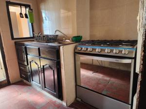 a kitchen with a stove and a sink in it at Camino Santa Prisca in Taxco de Alarcón
