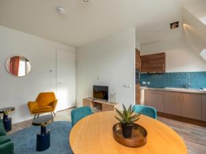 a living room with a table and chairs at Wifi and golden beaches Home in Zoutelande