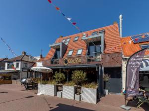 a building with a restaurant on a street at Romantic stay near Zoutelande in Zoutelande