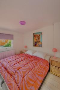 a bedroom with a bed and a painting of a dog at Ermwood Cottage in Erm