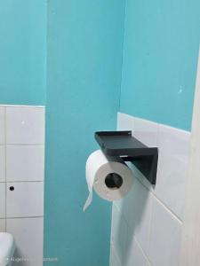 a toilet paper dispenser on a wall in a bathroom at Oge's Apartment in Bradford +21 photos