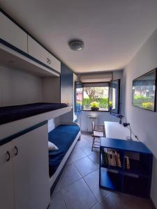 a small room with a bed and a desk in it at Lago Maggiore Gardens Apartment in Intra +25 photos