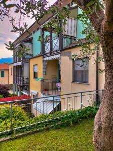 a house with a fence in front of it at Lago Maggiore Gardens Apartment in Intra