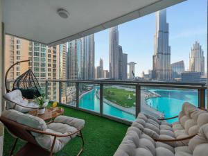 a balcony with chairs and a view of a city at Panoramic Burj 5br Condo with Full Led & Fountain View in Dubai