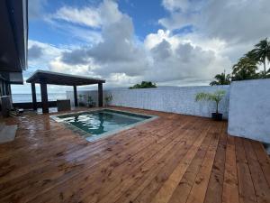 a swimming pool on the deck of a house at Fare Vaitaua in Faaone