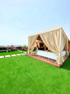 una tienda de campaña en un césped con hierba verde en Luxury Penthouse with Private Rooftop Lounge & City View - Lekki Home Fairy, en Lekki 22 fotos más