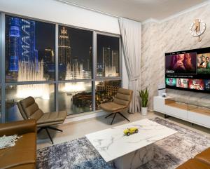 a living room with a view of a city at Panoramic Burj 5br Condo with Full Led & Fountain View in Dubai