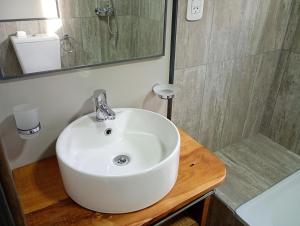 a bathroom with a white sink and a shower at Cielo Sur Balsas Loft in Villa La Angostura +12 photos