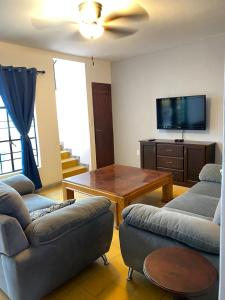 a living room with a couch and a table at La Casa De Don Rámon in Guadalajara +52 photos