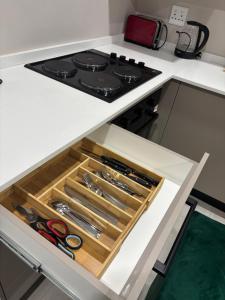 a drawer in a kitchen with some scissors at Tranquil Stays in Polokwane +24 photos