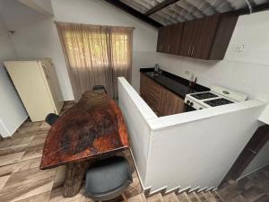 a kitchen with a wooden table in the middle of it at Casa Hotel San Gil in San Gil