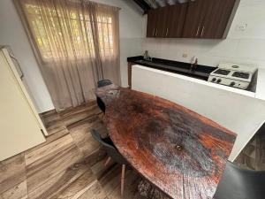 a kitchen with a wooden table in a room at Casa Hotel San Gil in San Gil +2 photos