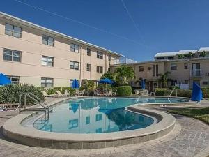a large swimming pool in front of a building at St Pete Beach in St. Pete Beach