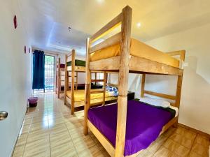 a bedroom with three bunk beds in a room at Hostal Amate Taxco in Taxco de Alarcón