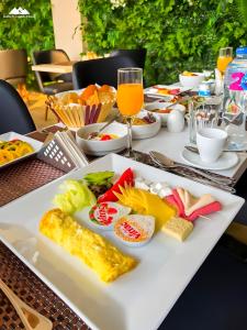 a table with a plate of food and a glass of orange juice at SOFIA PYRAMIDS & SPHINX HOTEL with free pool access in Cairo