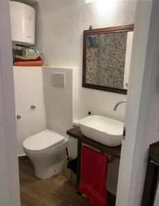 a bathroom with a white toilet and a sink at Casa Delfino in Sanremo