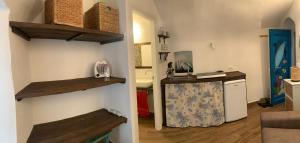 a kitchen with a counter and a kitchen with a sink at Casa Delfino in Sanremo +8 photos
