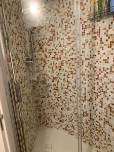 a bathroom with a shower with a glass door at Casa Delfino in Sanremo