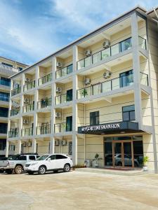 a large building with cars parked in front of it at Times Mansion Hotel Queen Room in Freetown
