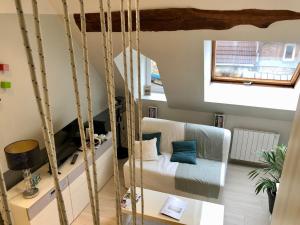 a room with a swinging bed and a window at City Escape Space in Chaumont +10 photos