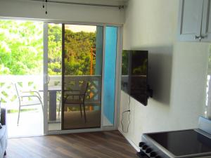 a kitchen with a sliding glass door to a balcony at 204 Batts Rock Beach Condos in Saint Michael