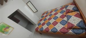 a bed in a room with a box with different colored ties at Mahadev Residency in Tiruvannāmalai