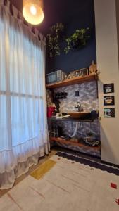 a bathroom with a sink and a window at Loft do QUINTAL 21 in Serra +45 photos